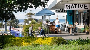 Enjoy a casual dining experience under a shaded canopy with ocean views.