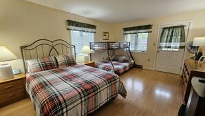 A bedroom with two beds, a nightstand, a dresser, and a door. - Mt Views from #238 Two Bedroom Condo (Lincoln)