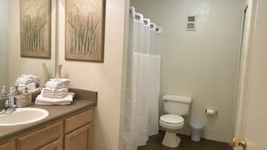 Combined shower/bathtub, towels, toilet paper