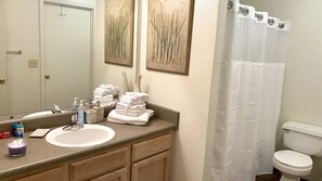 Combined shower/bathtub, towels, toilet paper