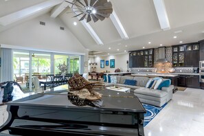 Relax in this spacious living space with a comfortable seating area, dining table, and kitchen with a large island.