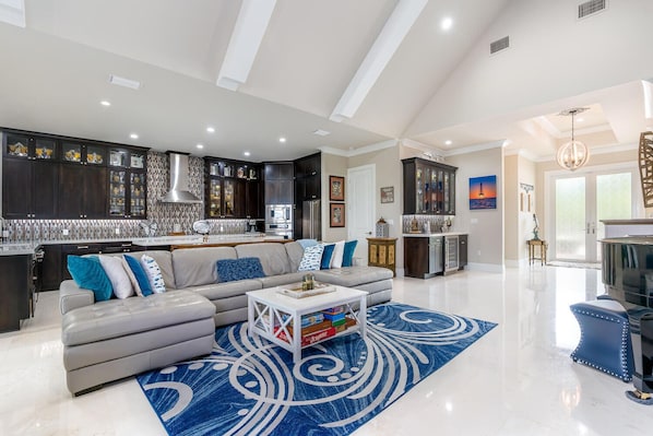 Relax in this spacious living area with a comfortable sofa, coffee table, and modern kitchen.