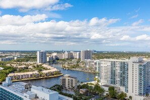 A high-rise hotel with multiple floors, a waterfront view, and a marina in the background. - Hyde Side Ocean View 1 Bedroom Condo by RedAwning (Hollywood)