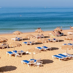 On the beach, white sand, sun-loungers, beach umbrellas