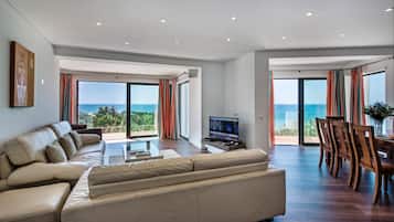 Deluxe Villa, Patio | Living area | 60-inch flat-screen TV with cable channels, TV