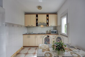 Family Apartment, 2 Bedrooms (Apartment Basic 1) | Private kitchen | Fridge, stovetop, electric kettle, cookware/dishes/utensils