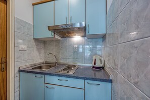 Fridge, stovetop, electric kettle, cookware/dishes/utensils