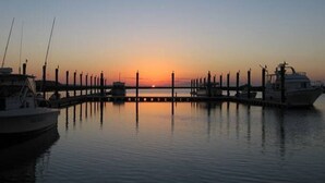 A marina at sunset with boats docked and calm water. - 338 Capt John Fripp Villa W/Cart, Cards Available! (Fripp Island)