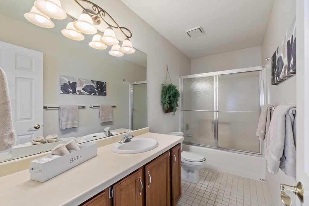 A modern bathroom with a vanity, sink, and mirror.