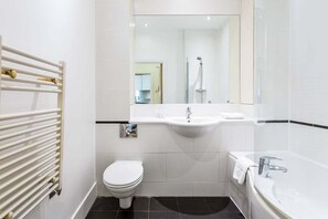 Bathtub, eco-friendly toiletries, hair dryer, towels