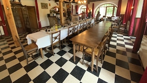 Un comedor con suelo a cuadros, mesas y sillas de madera.