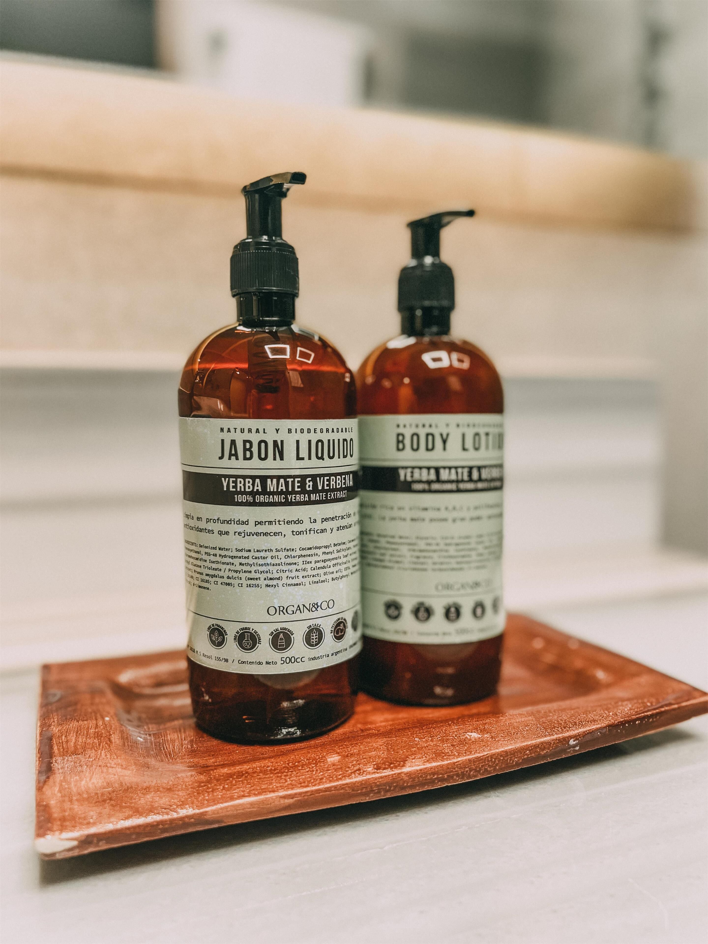 Two bottles of organic body lotion on a wooden tray.