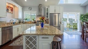 A spacious kitchen with granite countertops, stainless steel appliances, and a large island.