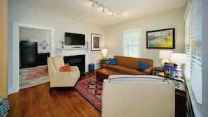 A living room with a fireplace, a television, a sofa, and a coffee table.