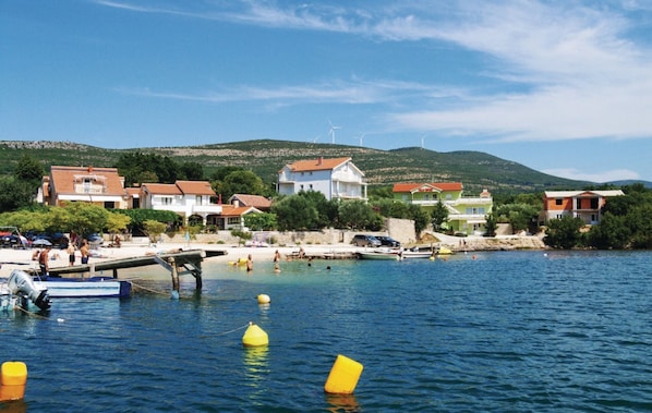 Enjoy waterfront views and access to a sandy beach from this coastal property.