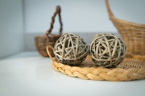 Two spherical wicker balls on a woven tray, with a wicker basket in the background. - Aisopos Myths Athens (Athens)