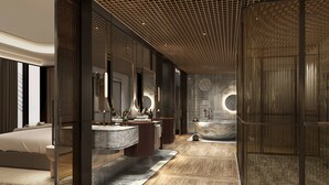 A modern bathroom with a large bathtub, a vanity with multiple sinks, and a large mirror.