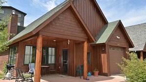 A wooden cabin with a covered porch, a dining area, and a garage. - Mountain Retreat | Fire Pit | 3 Blocks off Main St. (Grand Lake)