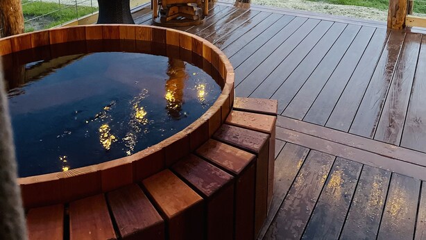 A wooden deck with a hot tub, chairs, and a fire pit. - Secluded cabin on 75 acres 360 views cedar hot tub infrared sauna outdoor Shower (Viola)