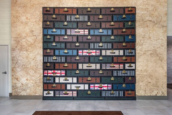 A wall of suitcases with various flags, arranged in a grid pattern.