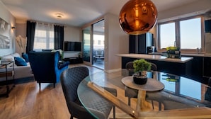 A modern apartment with a living room, dining area, and kitchen. - Penthouse Luxury Suite (Zadar)