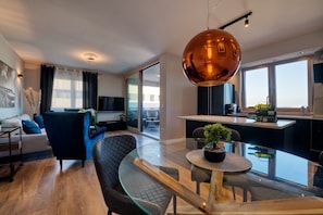 A modern apartment with a living room, dining area, and kitchen. - Penthouse Luxury Suite (Zadar)