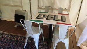 Une table portant l’inscription « DELLI », entourée de chaises blanches.