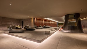 A modern lobby with a seating area featuring round chairs and a central column.