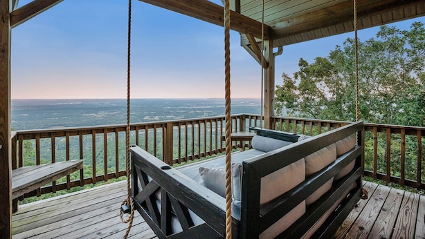 A wooden deck with a swing chair and a bench, overlooking a scenic landscape. - ON Mt Nebo State Park Luxury Mountain Retreat with Above the-clouds sunrise view (Dardanelle)