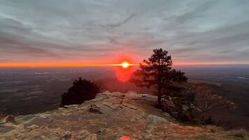 A rocky landscape with a sunset in the background.