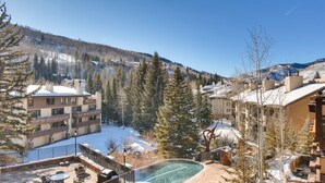 A resort with a pool, snow-covered grounds, and mountainous views. - 1a-owb 36 (Vail)