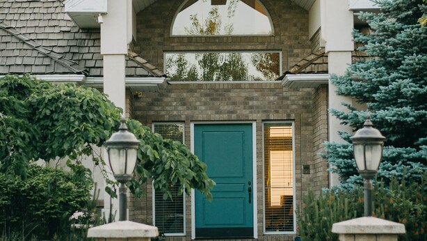 A house with a brick facade, a green door, and a small porch with two lantern-style lights. - The perfect place for a vacation or reunion.  (Saint Anthony)