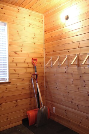 A room with wooden walls, a window with blinds, a shovel, and a rake leaning against the wall. - Hakuba Shirousagi 3LDK 6person rental villa / Kitaazumi-gun Nagano (Kitaazumi-gun)