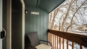 A covered porch with a chair and a view of a snowy landscape. - Walking distance historic downtown Sheridan (Sheridan)