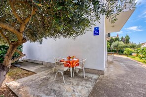 A small outdoor seating area with a table and chairs, a sign indicating room number 8, and a tree providing shade. - Seaside Apt Basic 2 w/ Terrace, Vir, Croatia (Vir)