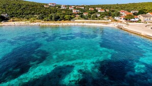 A coastal village with clear turquoise waters, houses on a hillside, and a sandy beach. - Seaside Studio Basic 3 w/ Terrace, Vir, Croatia (Vir)