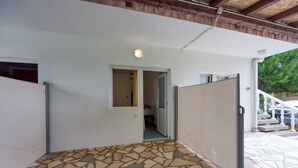 A room with a stone-patterned floor, a white door, and a view of a staircase leading outside. - Seaside Studio Basic 3 w/ Terrace, Vir, Croatia (Vir)