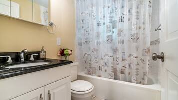 Bathtub, hair dryer, towels, soap