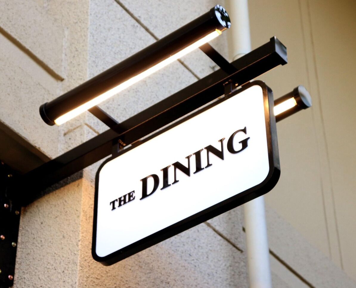 A sign for "The Dining" restaurant.
