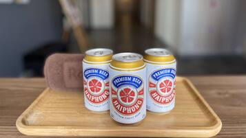 Three cans of Haiphong beer on a wooden tray.