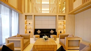 A modern living room with a central coffee table, sofas, and built-in shelving. - Roygent Parks Hai Phong (Hai Phong)