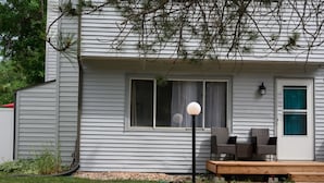 A house with a porch, a window, and a lamp post.