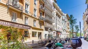 A hotel with balconies, a sign reading 'HOTEL DE SUEDES,' and parked scooters on the street. - SUEDE  AP4207 by Riviera Holiday Homes (Niza)