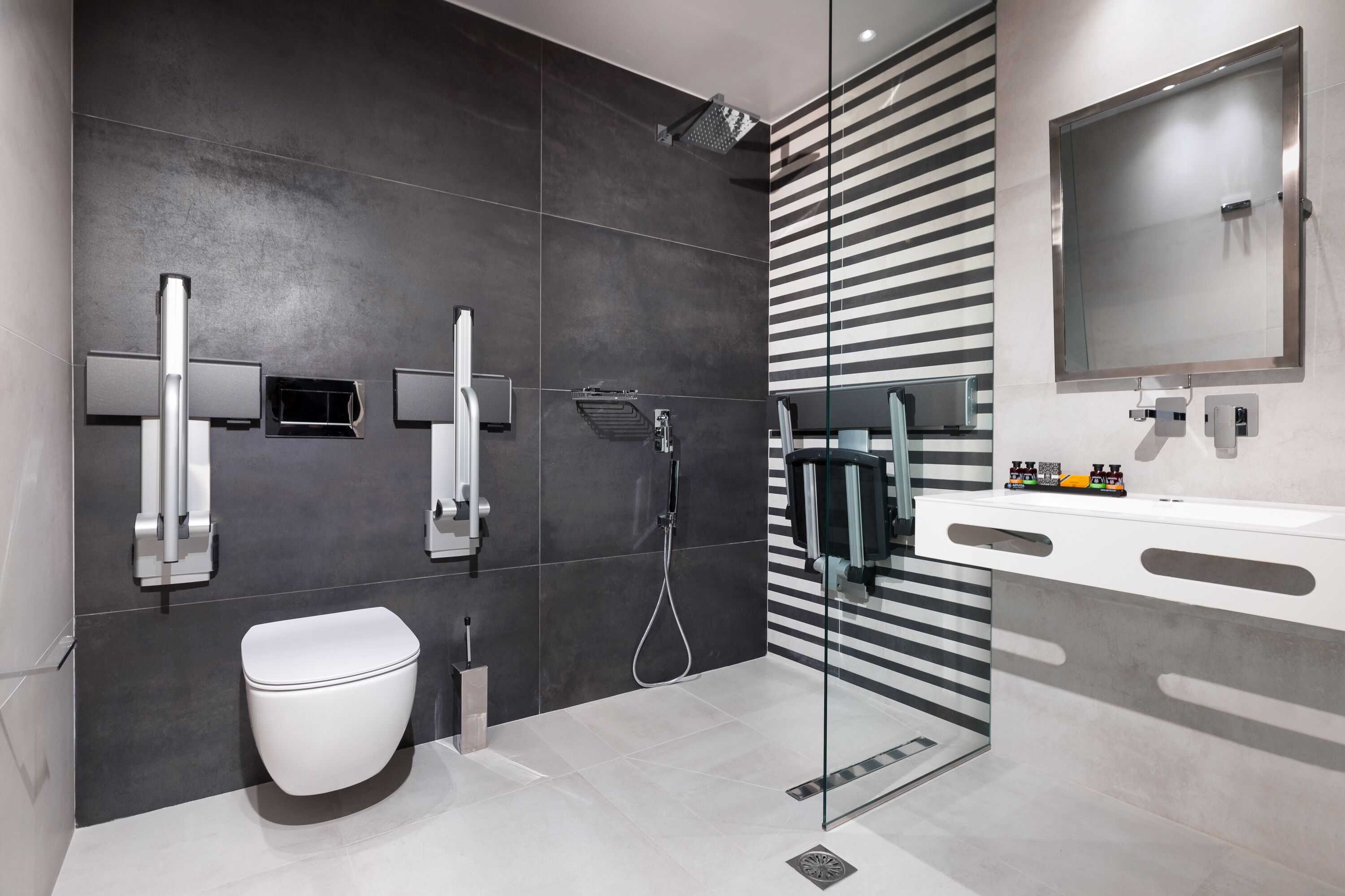 A modern bathroom with a toilet, bidet, and shower.