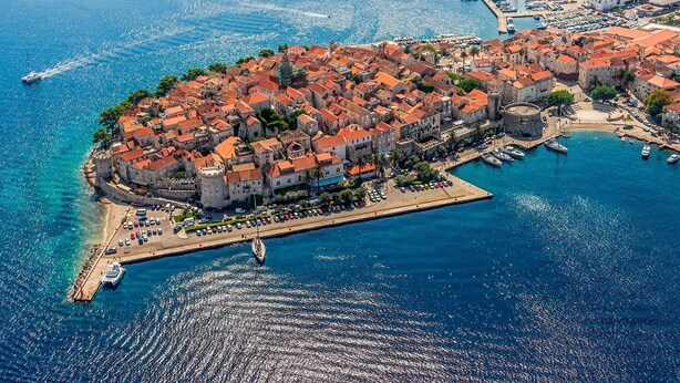 An aerial view of a coastal town with a historic center, marina, and waterfront promenade. - A1 - Luxury apt in Center, Just 5min From Beach (Korcula)