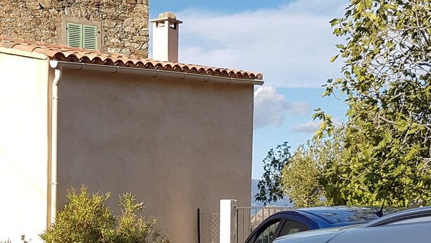 A building with a stone facade and a tiled roof. - Small apartment 15 minutes from Saint Florent overlooking CAP CORSICA (Santo-Pietro-di-Tenda)