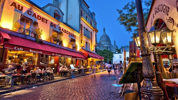 A cobblestone street lined with cafes and restaurants, including 'Au Cadet de Gascogne'. - 4-room apartment with 3 bedrooms in Montmartre A/C near the metro (Paris)