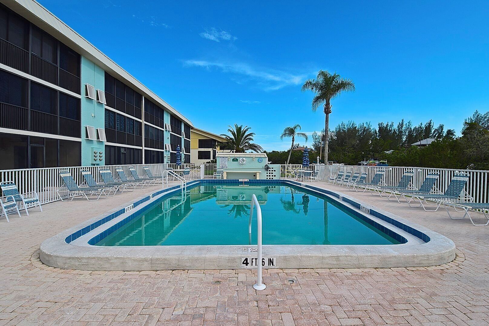 A rectangular pool with a white border and a sign indicating its dimensions.