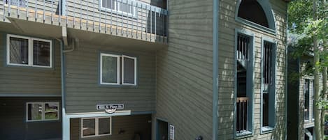 A multi-story building with a sign reading "451 S. Pine St." and a visible entrance with steps.