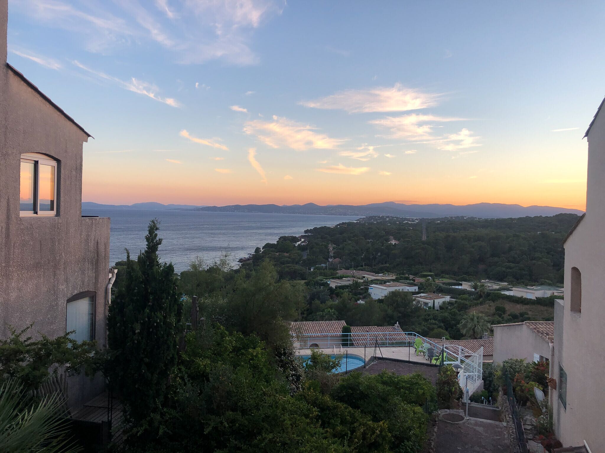 A residential area with a view of the sea and distant mountains.